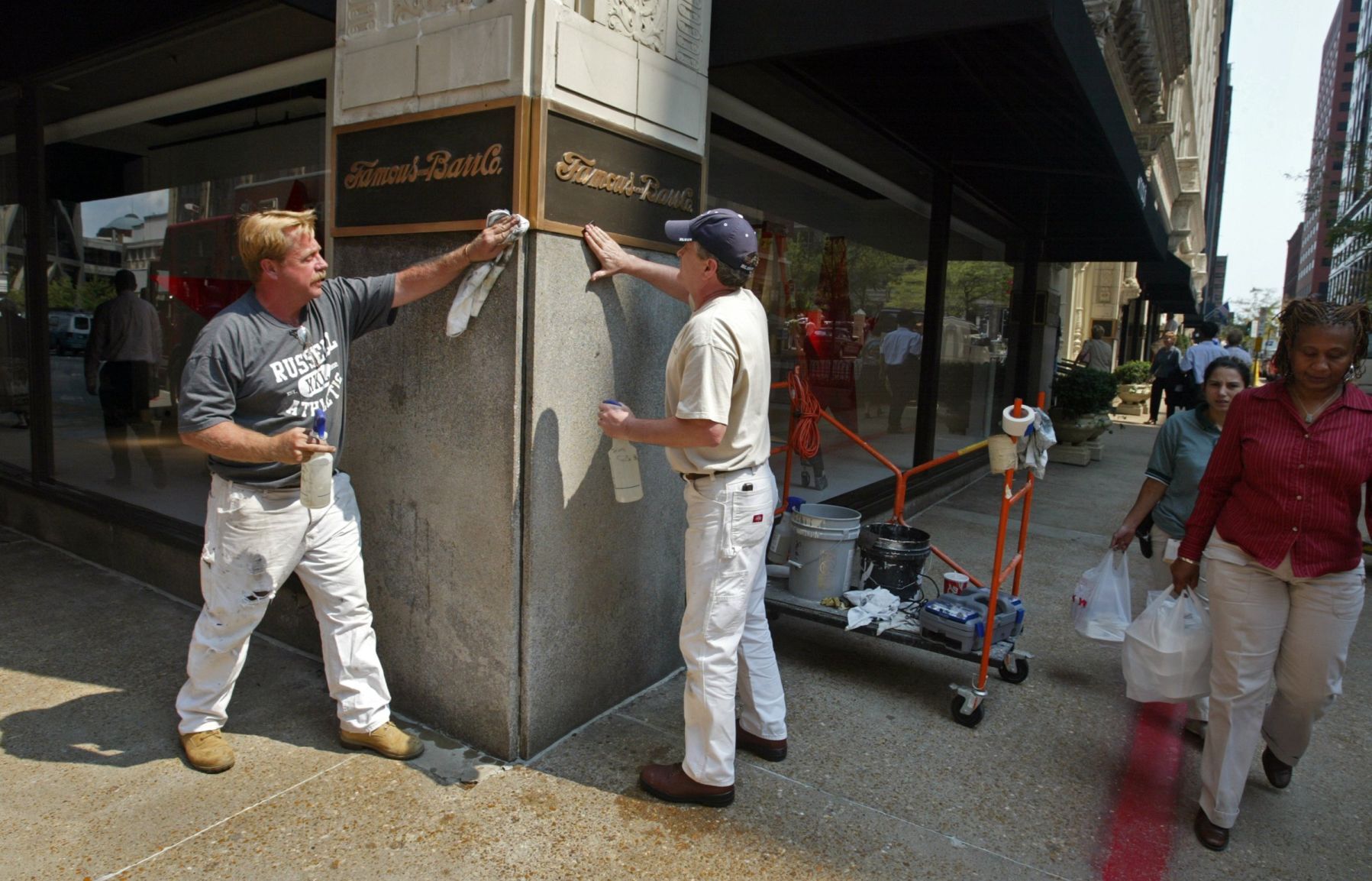 Workers polish the old Famous-Barr signs on Macy's in 2006